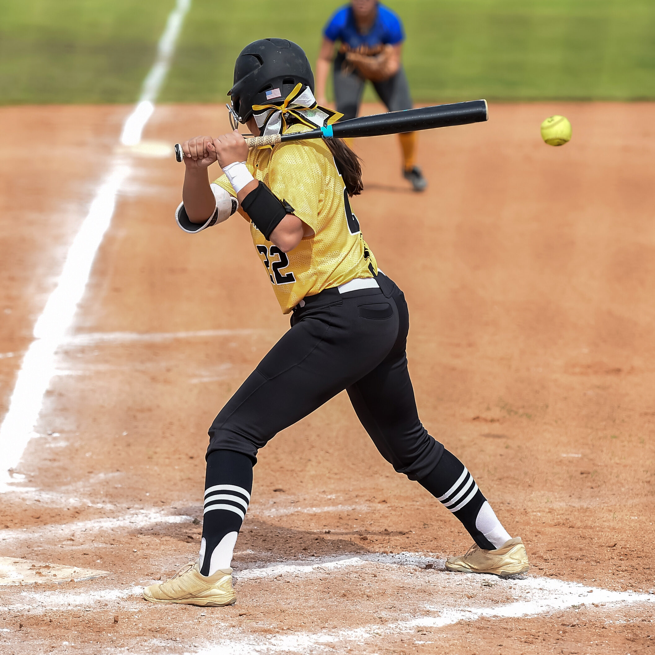 Girls in action playing in a softball game
